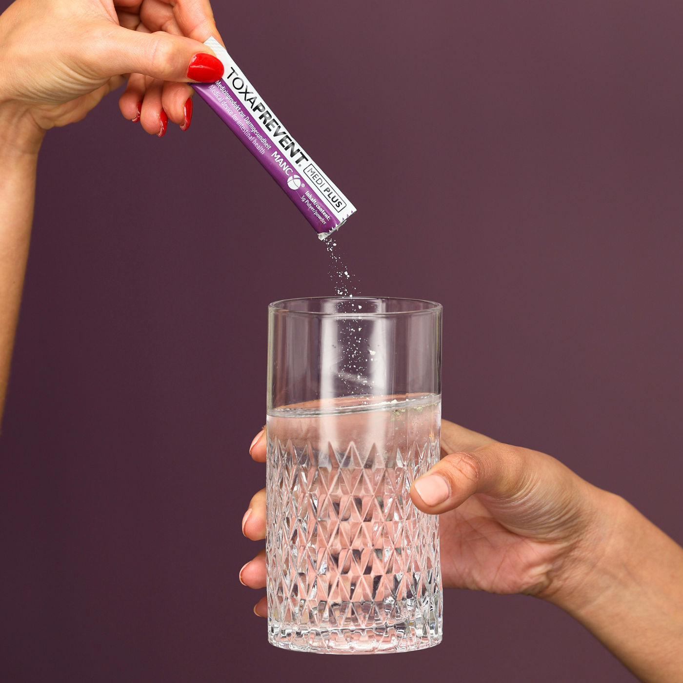 Pouring Toxaprevent into glass of water