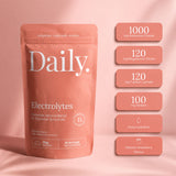A stand-up pouch of Daily Electrolytes in a dusty pink color, shown next to seven matching pink informational badges detailing key electrolyte contents and benefits on a matching pink background.