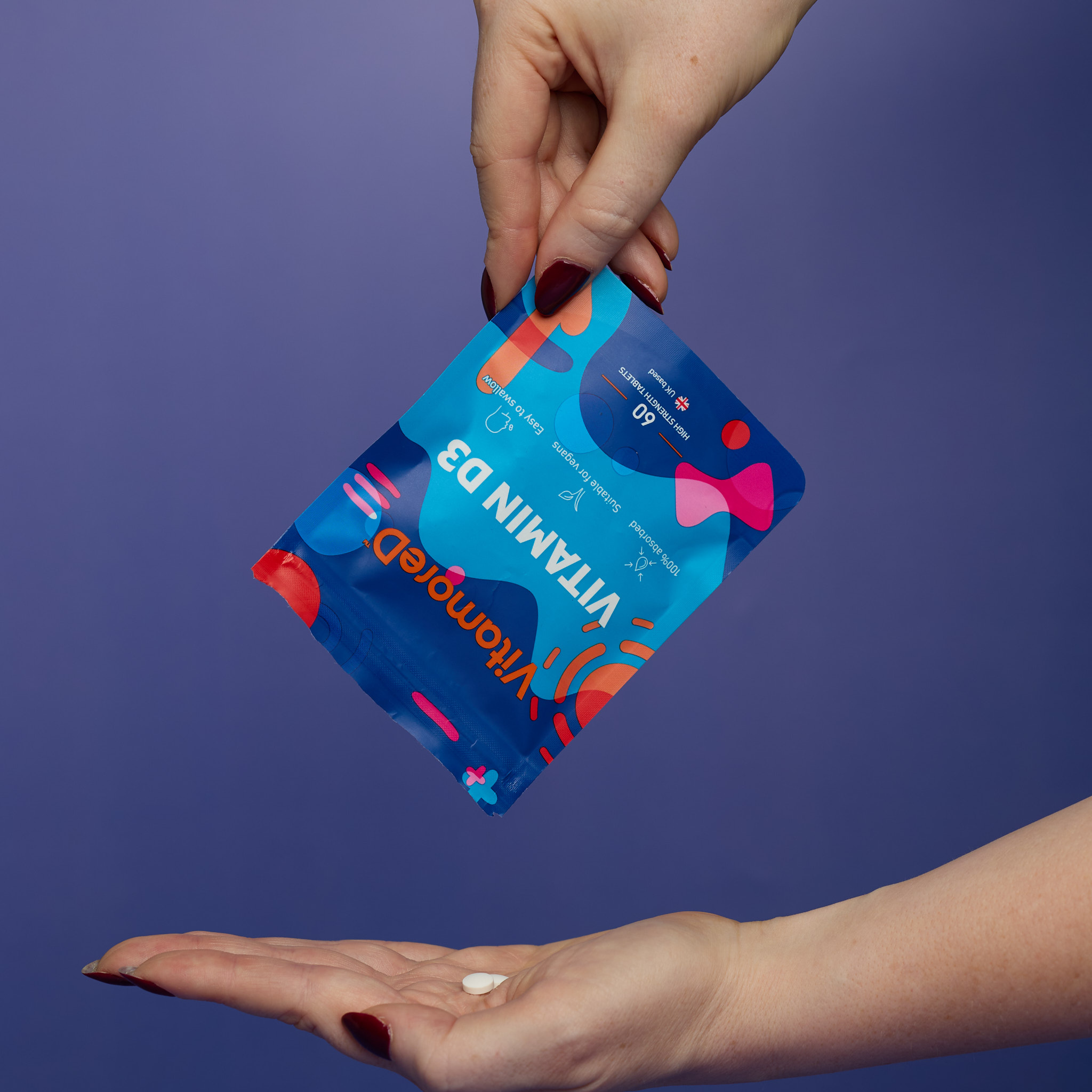woman holding vegan vitamin d3 calcifediol supplement